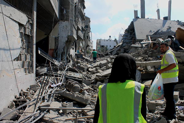 Integrantes de la Defensa Civil buscan sobrevivientes durante un bombardeo israelí en Gaza - Foto: Joe Catron