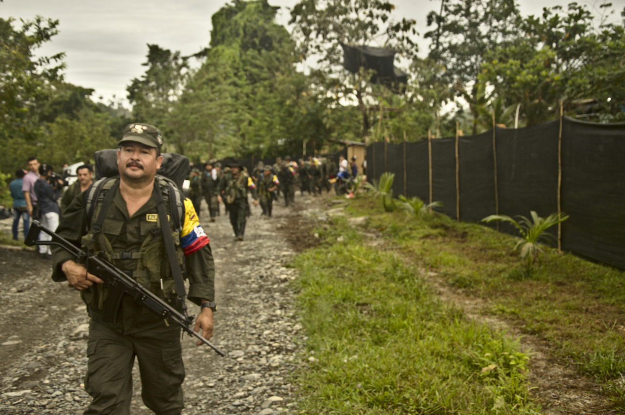 Un excombatiente de las FARC encabeza una fila de personas que se dirige al lugar del desarme. Foto: Andrés Gómez.